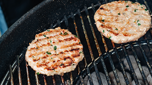 Chicken burgers on grill
